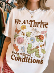 "We All Thrive Under Different Environments" slogan, colorful insect and floral print, regular-fit short-sleeved casual top.